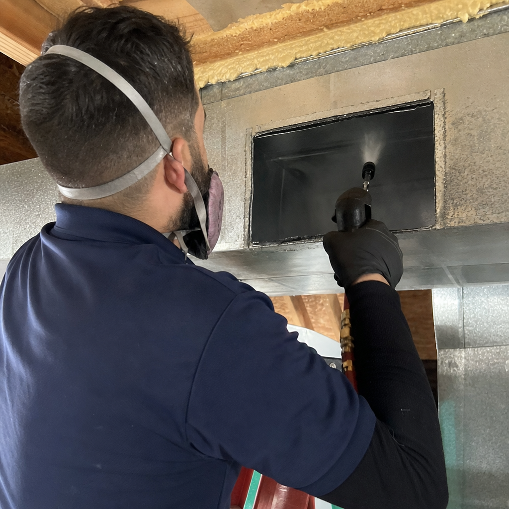 Technician performing professional air duct sanitization with specialized cleaning equipment in Acton, MA
